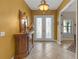 Inviting foyer with decorative tile flooring, and a ornate glass double door entry at 8414 Eagle Brook Dr, Land O Lakes, FL 34638