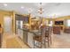 Modern kitchen island with granite countertops and bar stool seating, ideal for casual dining and entertaining at 8414 Eagle Brook Dr, Land O Lakes, FL 34638