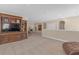 Open living room with large entertainment center, bright natural light and neutral walls and carpeting at 8414 Eagle Brook Dr, Land O Lakes, FL 34638