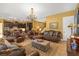 Spacious living room featuring a chandelier, comfortable seating, and seamless transition to the kitchen area, perfect for entertaining at 8414 Eagle Brook Dr, Land O Lakes, FL 34638