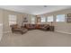 Spacious living room featuring neutral-colored walls and a large, comfortable leather sectional sofa at 8414 Eagle Brook Dr, Land O Lakes, FL 34638