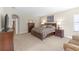 Comfortable main bedroom featuring a king size bed, a sitting area, and ensuite access at 8414 Eagle Brook Dr, Land O Lakes, FL 34638