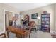 Comfortable home office with a large desk, an arm chair, and shelving for storage at 8414 Eagle Brook Dr, Land O Lakes, FL 34638