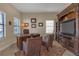 Well-lit office features a wooden desk and a built-in entertainment center perfect for a home office or study at 8414 Eagle Brook Dr, Land O Lakes, FL 34638