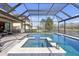 Screened-in pool area with a hot tub and lake view at 8414 Eagle Brook Dr, Land O Lakes, FL 34638