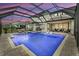 Enclosed pool with in-ground hot tub and ample patio space for relaxing and entertaining at 8414 Eagle Brook Dr, Land O Lakes, FL 34638