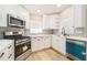 A kitchen featuring stainless steel appliances, quartz countertops, and white cabinets at 858 Harbor Hill Dr, Safety Harbor, FL 34695