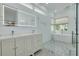 A spacious bathroom showcasing double sink vanity, tiled flooring, and a free-standing tub at 872 Live Oak Ne Ter, St Petersburg, FL 33703