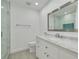 Modern bathroom features a glass shower, marble countertops, and a large mirror at 872 Live Oak Ne Ter, St Petersburg, FL 33703