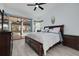 Primary bedroom featuring wood-look tile flooring and direct access to the screened pool at 872 Live Oak Ne Ter, St Petersburg, FL 33703