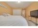 Bright bedroom with a large closet, carpeted floors and TV at 872 Live Oak Ne Ter, St Petersburg, FL 33703