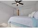 Cozy bedroom featuring a ceiling fan, closet, and decorative wall decals at 872 Live Oak Ne Ter, St Petersburg, FL 33703