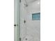Elegant marble shower with glass door and mosaic tile accent at 872 Live Oak Ne Ter, St Petersburg, FL 33703