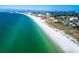 Aerial view of the pristine beach, showcasing the beautiful coastline, turquoise waters, and beachfront homes at 8921 Blind Pass Rd # 339, St Pete Beach, FL 33706