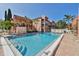 Inviting community swimming pool with lounge chairs, palm trees, and appealing condo units at 8921 Blind Pass Rd # 339, St Pete Beach, FL 33706