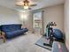 Multi-purpose bedroom with a cozy futon, exercise bike, and bright window view at 9715 Sage Creek Dr, Ruskin, FL 33573