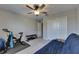 Bedroom featuring a ceiling fan, a closet, and fitness equipment, offering space for exercise and relaxation at 9715 Sage Creek Dr, Ruskin, FL 33573