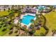 Belmont's community pool surrounded by tropical landscaping, lounge chairs, and shade at 9715 Sage Creek Dr, Ruskin, FL 33573