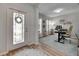 Inviting entryway with decorative glass door, hardwood floors and an adjacent office space bathed in natural light at 9715 Sage Creek Dr, Ruskin, FL 33573