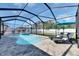 Beautiful screened-in pool area with a spa, lounge chairs, and a well-maintained patio at 9715 Sage Creek Dr, Ruskin, FL 33573