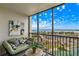 Balcony features a comfortable seating area with views of the water at 10355 Paradise Blvd # 909, Treasure Island, FL 33706