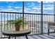 Balcony featuring city views and a table with a fern on top of a striped rug at 10355 Paradise Blvd # 909, Treasure Island, FL 33706