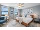 Bedroom with natural light, complete with a cozy chair and art at 10355 Paradise Blvd # 909, Treasure Island, FL 33706