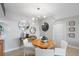 Bright dining area with round table, modern light fixture, and decorative mirrors at 10355 Paradise Blvd # 909, Treasure Island, FL 33706