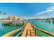 A low-angle shot shows a dock leading into a tranquil body of water at 10355 Paradise Blvd # 909, Treasure Island, FL 33706