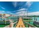 A marina dock with boats is pictured on a clear, sunny day at 10355 Paradise Blvd # 909, Treasure Island, FL 33706
