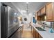 Updated kitchen overlooking dining area, featuring stainless appliances and quartz countertops at 10355 Paradise Blvd # 909, Treasure Island, FL 33706