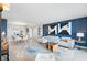Bright and modern living room featuring neutral walls, a large couch, and a view of the dining area at 10355 Paradise Blvd # 909, Treasure Island, FL 33706
