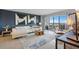 Bright and modern living room with stylish furniture and a large window that leads to the balcony at 10355 Paradise Blvd # 909, Treasure Island, FL 33706