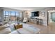 Inviting living room with a view, featuring a large TV and stylish decor at 10355 Paradise Blvd # 909, Treasure Island, FL 33706