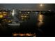 Night view of the marina showcasing the lights of the city and full moon with boats docked in the water at 10355 Paradise Blvd # 909, Treasure Island, FL 33706