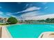A beautiful pool with a view of the marina and blue skies at 10355 Paradise Blvd # 909, Treasure Island, FL 33706