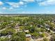 An aerial view of a neighborhood filled with mature trees and beautiful homes under a blue sky at 1119 77Th N St, St Petersburg, FL 33710
