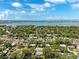 Panoramic aerial view of a neighborhood near the water with blue skies and fluffy clouds at 1119 77Th N St, St Petersburg, FL 33710