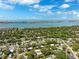 Aerial view of a neighborhood near the water with houses nestled among lush greenery at 1119 77Th N St, St Petersburg, FL 33710