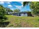 Backyard of a home with a grassy area and blue exterior at 1119 77Th N St, St Petersburg, FL 33710
