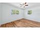 This bright bedroom features two windows, wood floors, and fresh white walls at 1119 77Th N St, St Petersburg, FL 33710