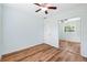 Bright bedroom features a ceiling fan, wood floors, and mirrored closet at 1119 77Th N St, St Petersburg, FL 33710