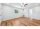Comfortable bedroom with wood-look flooring, a ceiling fan and a window at 1119 77Th N St, St Petersburg, FL 33710