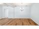 Open-concept dining area with wood flooring and elegant chandelier at 1119 77Th N St, St Petersburg, FL 33710