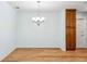 Bright dining area featuring a chandelier and wood-look flooring at 1119 77Th N St, St Petersburg, FL 33710