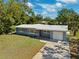 Beautiful single Gathering home with a well-kept lawn and driveway leading to the attached garage at 1119 77Th N St, St Petersburg, FL 33710