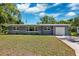 Charming single-story home with a well-maintained lawn and a large driveway at 1119 77Th N St, St Petersburg, FL 33710