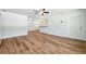 Open-concept living area with a ceiling fan and wood-look flooring throughout at 1119 77Th N St, St Petersburg, FL 33710