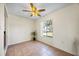 Dining area with tile floors, a modern ceiling fan and a bright window overlooking the landscaped yard at 11407 3Rd N St # 1, St Petersburg, FL 33716