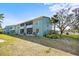 Exterior shot of building showing multiple screened in patios and mature landscaping at 11407 3Rd N St # 1, St Petersburg, FL 33716